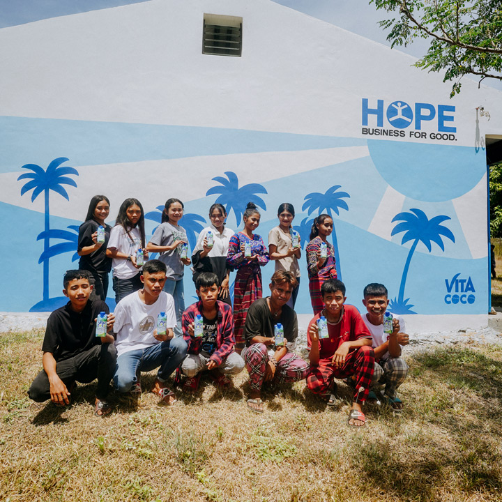 Children in one of our coconut growing communities in the Philippines stand outside a classroom built with the support of The Vita Coco Project. This space has evolved beyond a traditional classroom and now serves as a central gathering hub for the community as well.